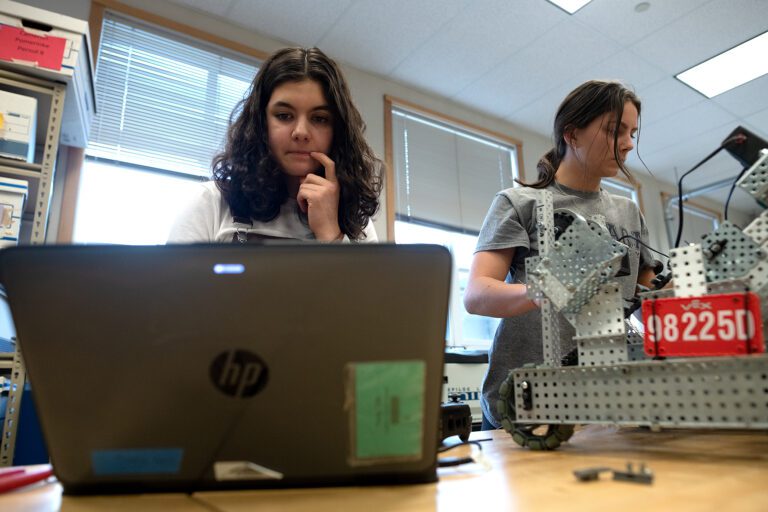 Bellingham junior Calla Young and sophomore Katie Knies try to solve a coding issue with their robot Feb. 8 during robotics class at Bellingham High School. "It's a good combination of frustrating and fun