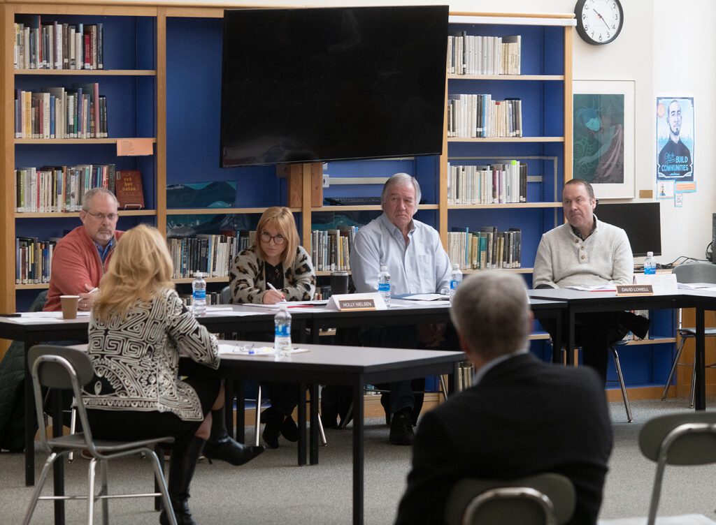 The Burlington-Edison School Board discussing in a library.