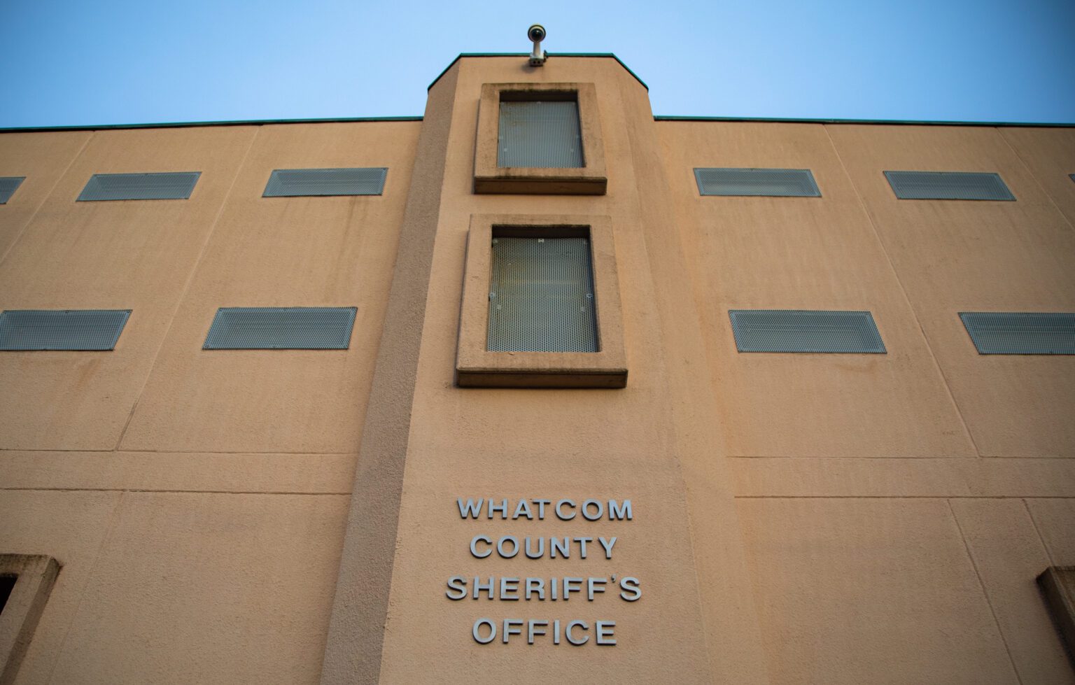 "Whatcom County Sheriff's Office" is listed on the side of an orange building.