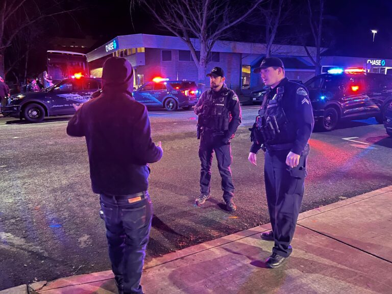 Bellingham police question a witness on the 100 block of East Magnolia Street March 10. An officer at the scene said they were investigating a knife assault.