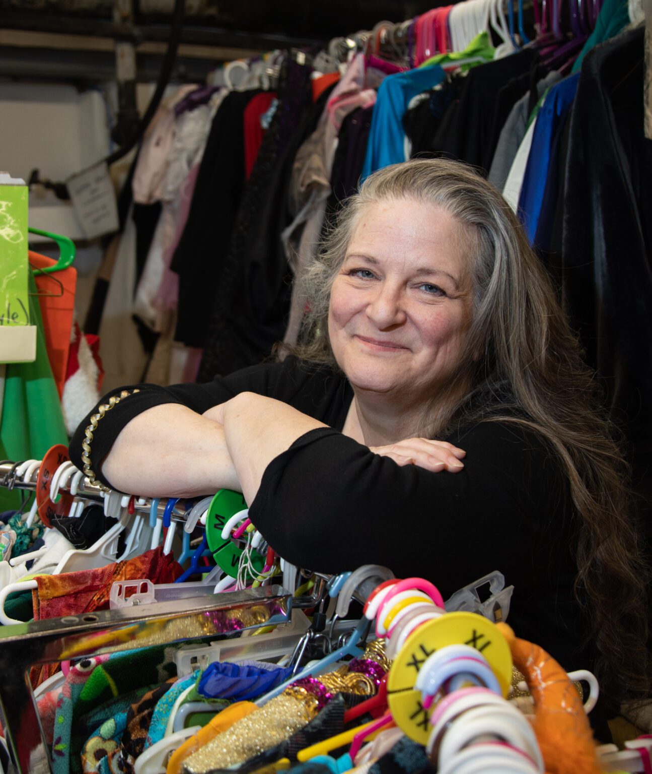 Dana Crediford stands in the crammed-to-the-gills costume shop at Bellingham Arts Academy for Youth (BAAY). Three years