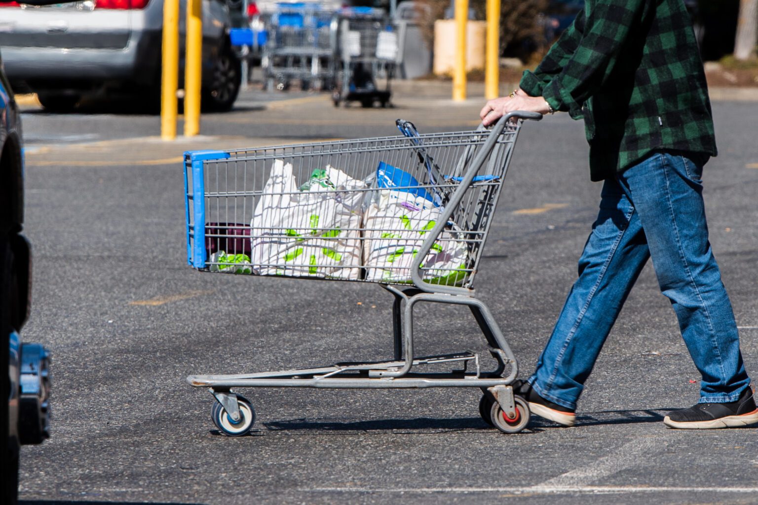 A shopper exits the Walmart store in Bellingham on March 29. Walmart will no longer provide plastic or paper bags at checkout in Washington state starting April 18