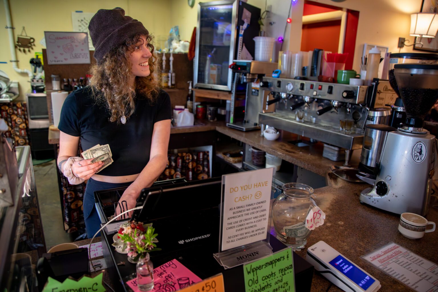Barista Hannah Stine gives change May 5 at Bellingham's Avellino Coffeehouse. Like many small
