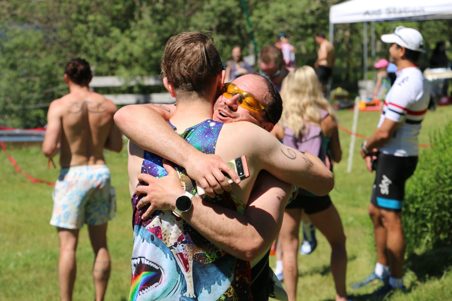 Triathlon finishers hug after the long-course Padden Triathlon race on June 25. The long-course race involved a half-mile of swimming