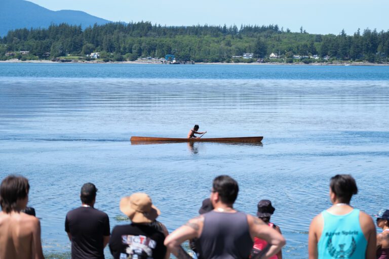 A solo kayaker pushes to the finish line during the festival on June 25. The war canoe races included different categories such as singles