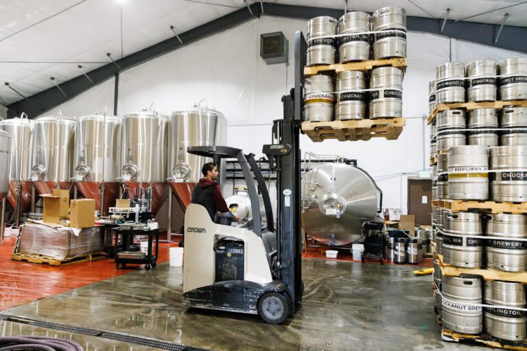 Brewer Jakub Rynkiewicz stacks kegs at Chuckanut Brewery in Burlington on June 29. Chuckanut recently collaborated with Reuben's Brews to produce a beer called 6:1