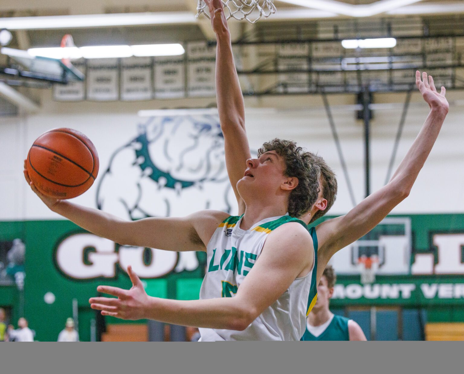 Lynden’s Trey Smiley goes under the basket for a shot as Lynden beat Sehome 76-49 at Mount Vernon High on Feb. 18.