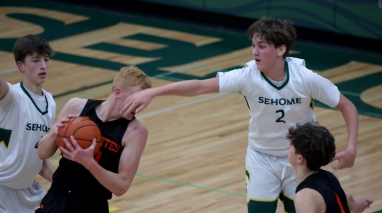 Sehome’s Isaac Lawrence fouls Blaine’s Cole Thomas as the Mariners beat Blaine 73-54 in a boys basketball game in December 2021.