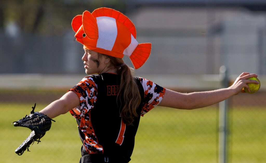 Blaine's Brie Smith sports a clown fish hat as her arm is outstretched for a throw.