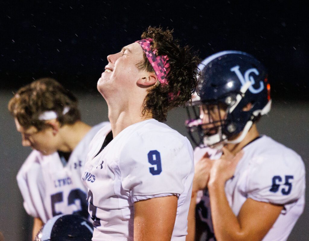 Lynden Christian's Brody Bouwman reacts as his team gathers after losing.