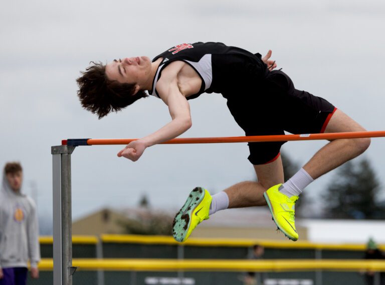Mount Baker's Cole Lukes clears the bar in the high jump on March 29 at the Trojan Twilight Invitational track meet at Meridian High School.