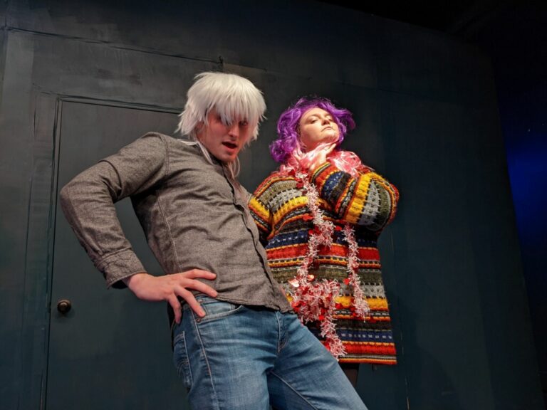 Chris Jones (left) and Cecilee Romano (right) wig out during a recent performance of "50 Shades of Velvet: An Improvised Romance Novel" at the Upfront Theatre.