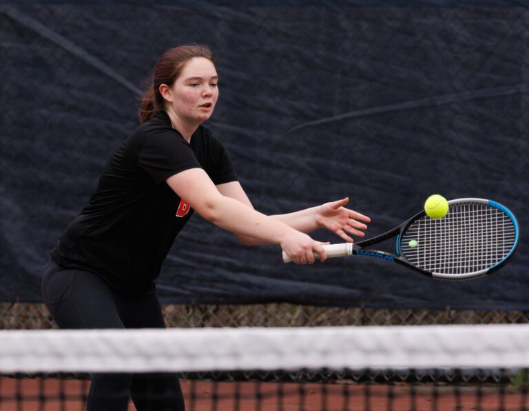 Bellingham's Haley Ask backhands a shot against Squalicum's Dylan McCoy in a singles match on March 22.