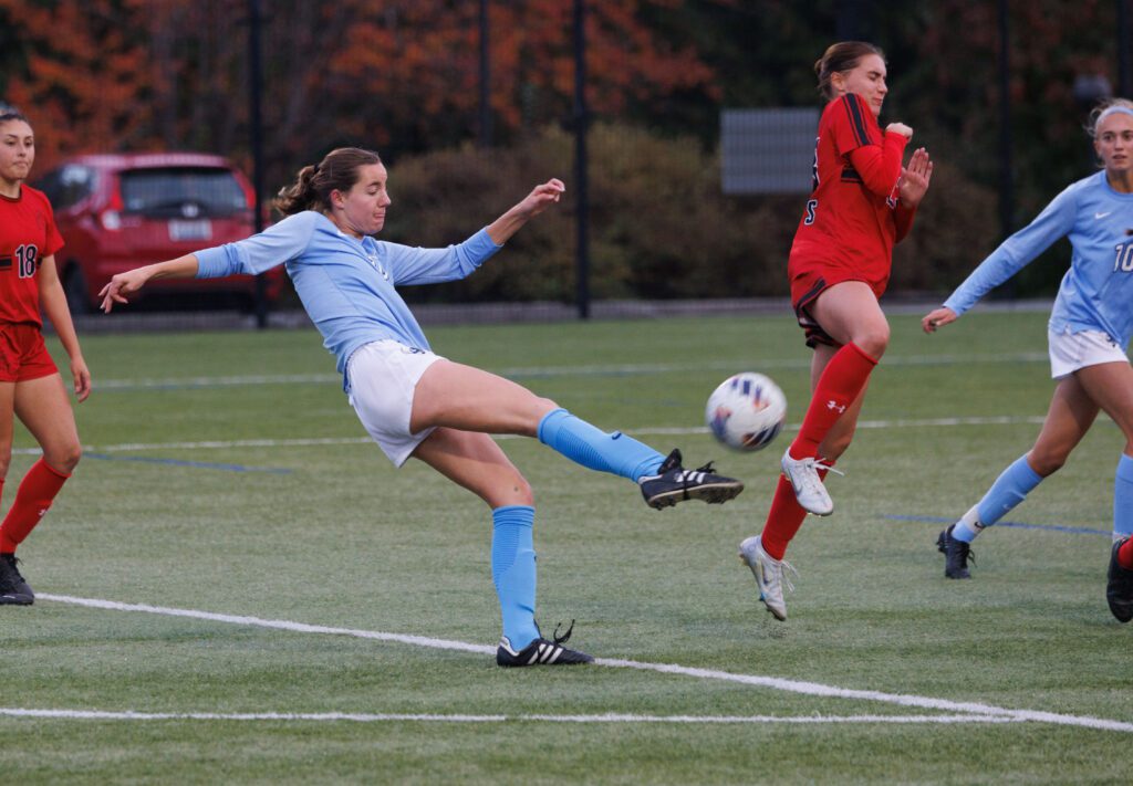 Western Washington University’s Tera Ziemer takes a shot at a goal as another player braces for impact.
