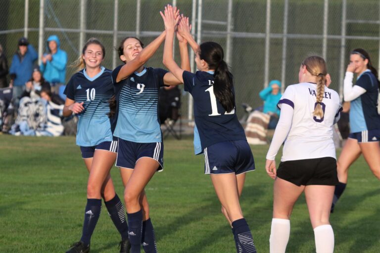 Lynden Christian's Demi Dykstra (9) celebrates a goal with teammates Alexie Hagen (10) and Daisy Poag in the Lyncs' 8-0 win over Nooksack Valley on Oct. 24.