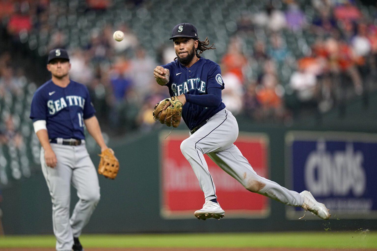 Seattle Mariners shortstop J.P. Crawford throws to first for the out after fielding a ground ball by Houston Astros' Kyle Tucker during the eighth inning of a baseball game
