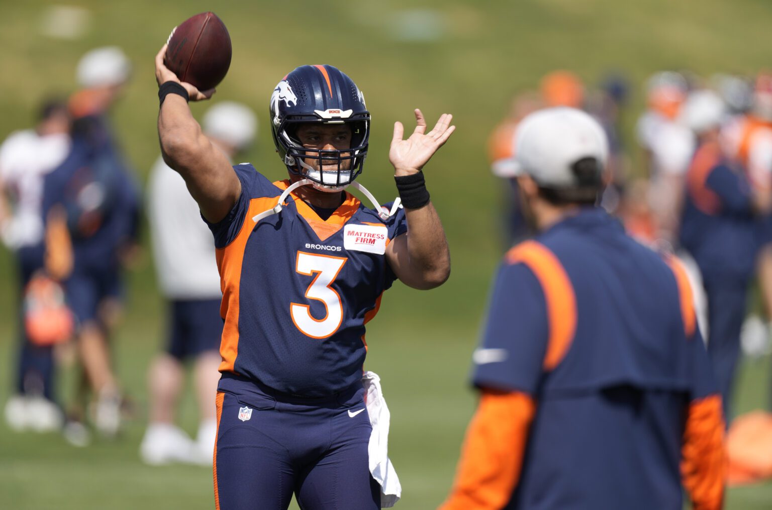 Denver Broncos quarterback Russell Wilson takes part in drills at the NFL football team's voluntary minicamp Wednesday