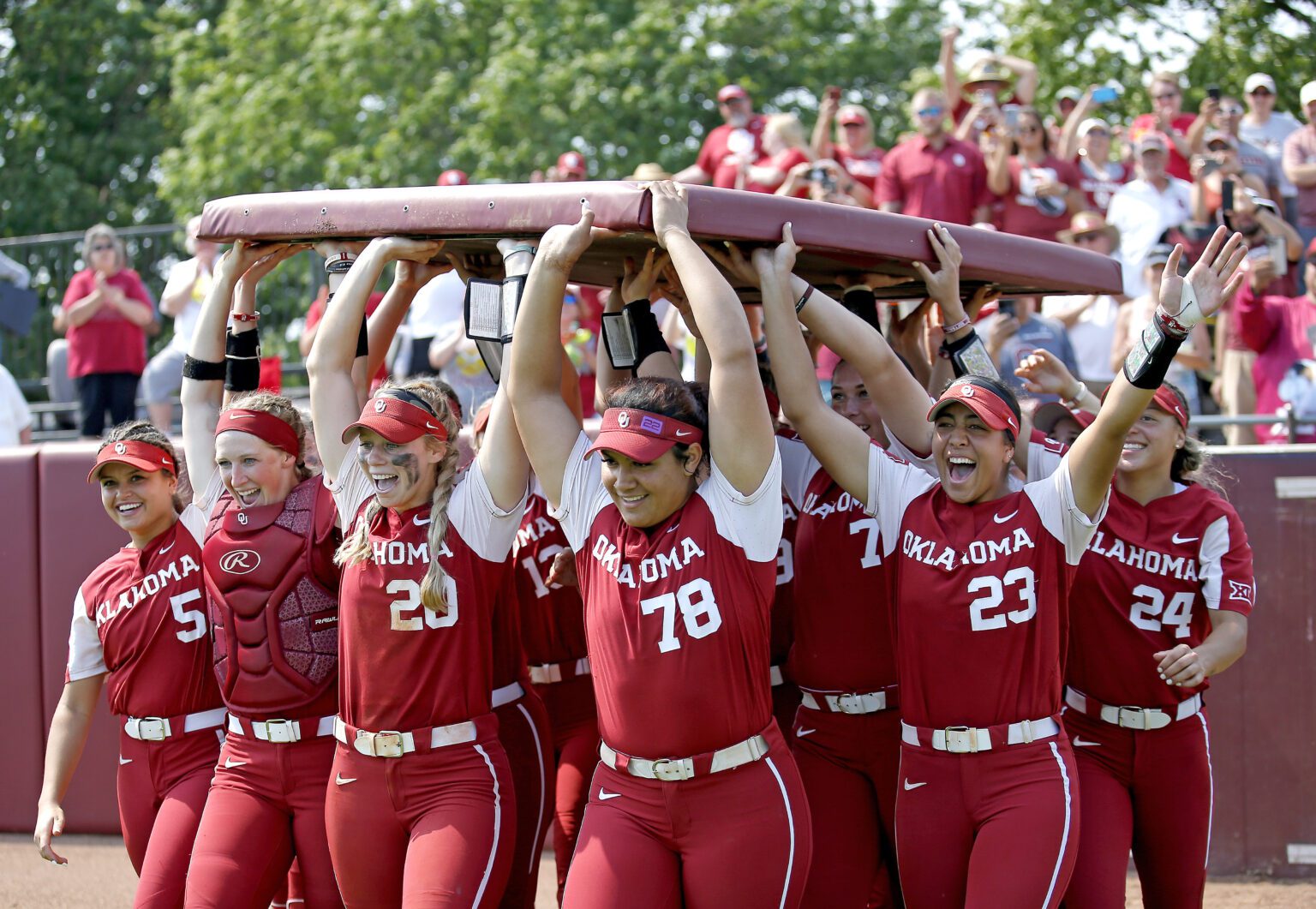 Oklahoma celebrates following an NCAA college softball super regional game against Central Florida in Norman