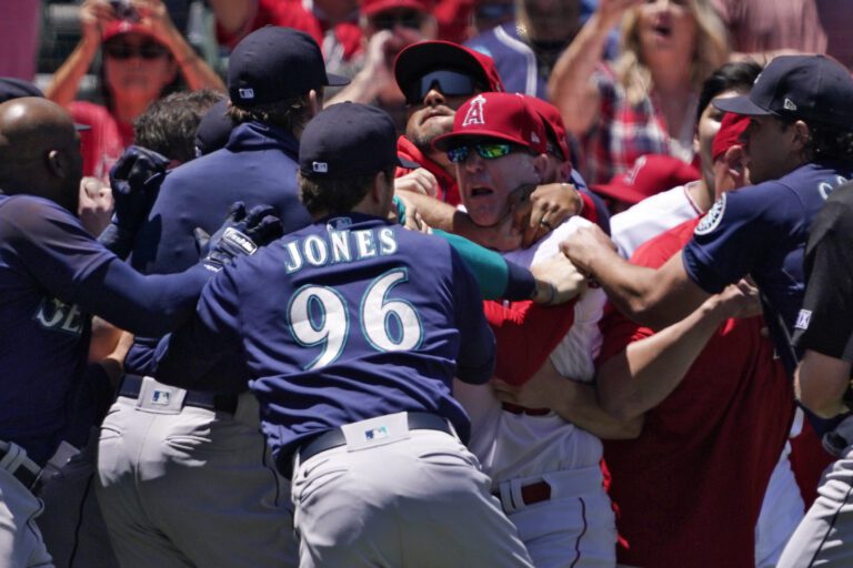 Several members of the Seattle Mariners and the Los Angeles Angels scuffle after Mariners' Jesse Winker was hit by a pitch during the second inning of a baseball game June 26 in Anaheim
