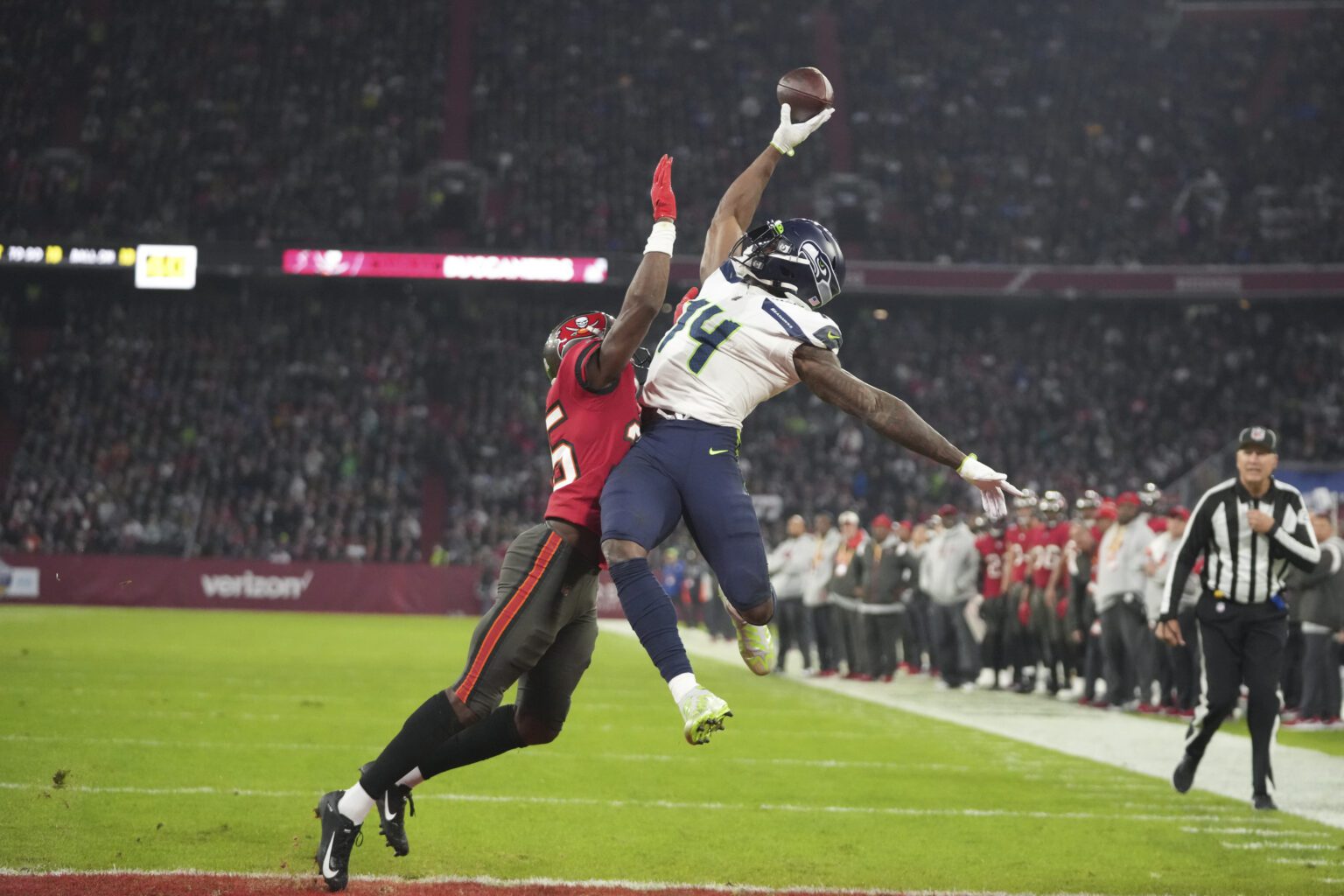 Seattle Seahawks' DK Metcalf (14) is defended by Tampa Bay Buccaneers' Jamel Dean (35) during the second half of an NFL football game in Munich