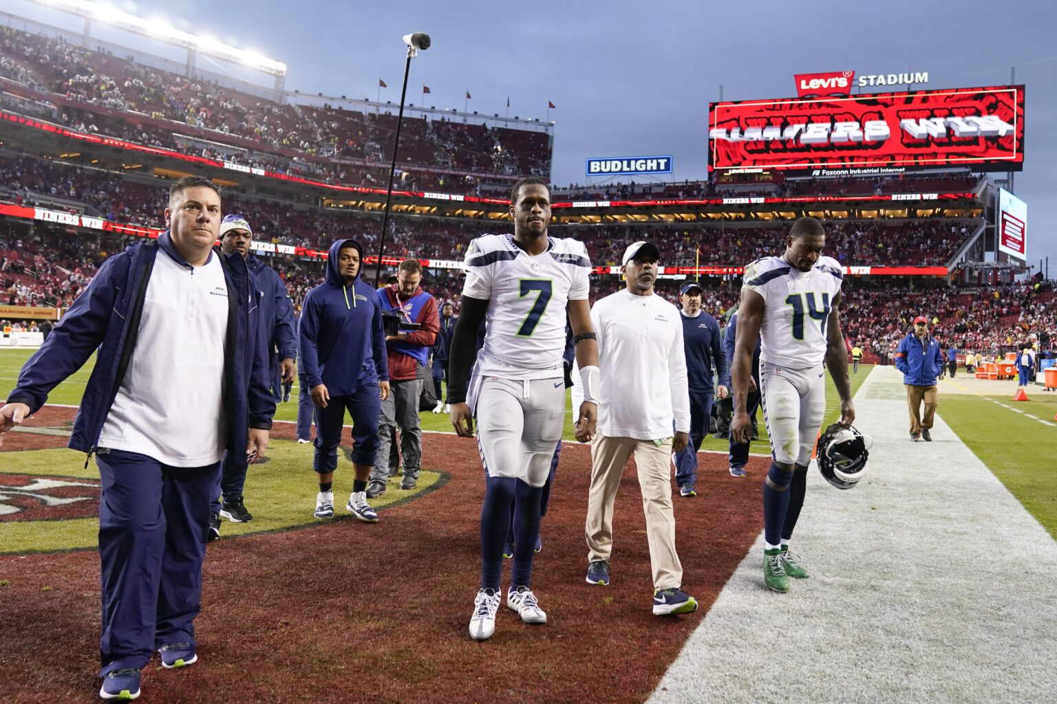 Seattle Seahawks quarterback Geno Smith (7) and wide receiver DK Metcalf (14) walk off the field after an NFL wild card playoff football game against the San Francisco 49ers in Santa Clara
