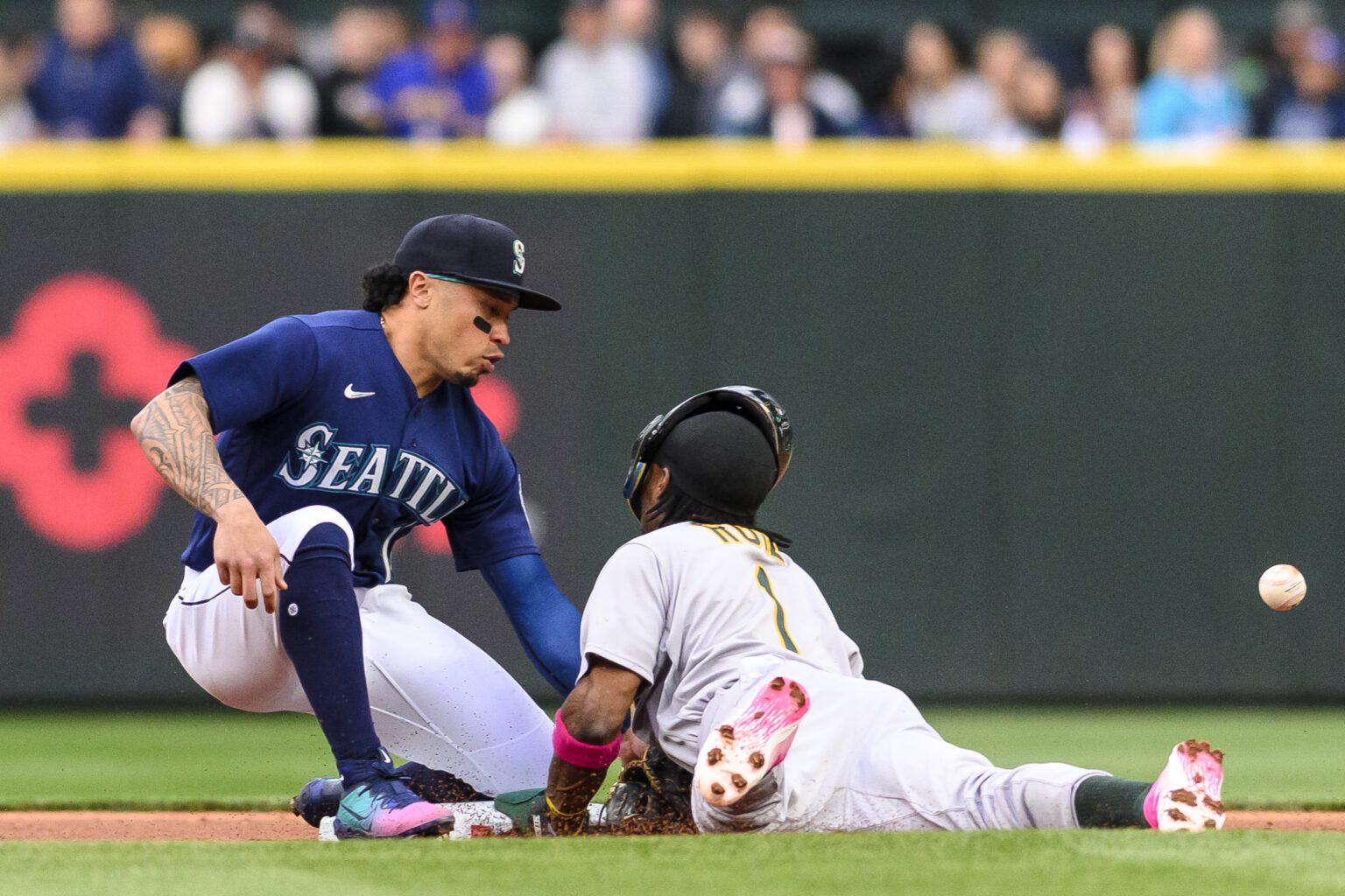Oakland Athletics' Esteury Ruiz (1) collides into Seattle Mariners second baseman Kolten Wong during the first inning of a baseball game
