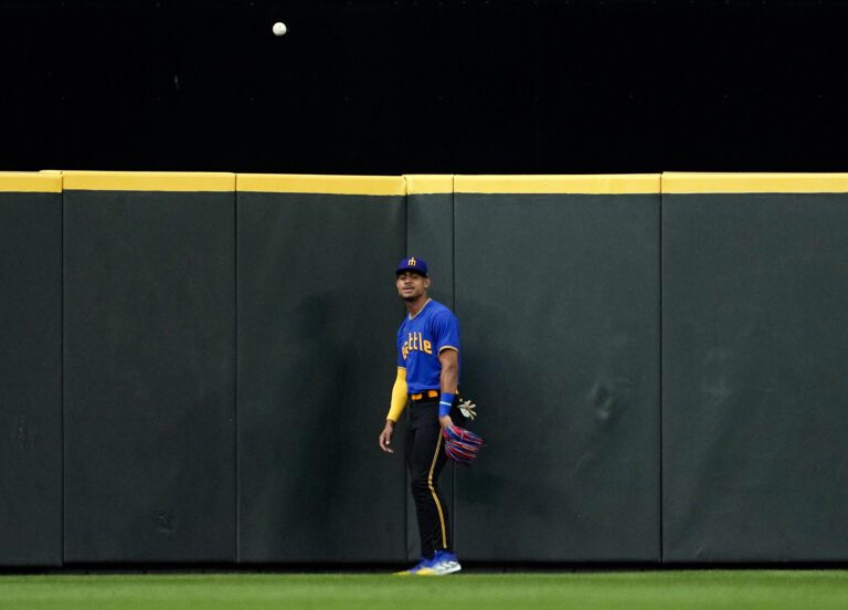 Seattle Mariners center fielder Julio Rodriguez watches as the ball from a two-run home run by Pittsburgh Pirates' Jack Suwinski bounces back up from center field during the fifth inning of a baseball game Friday