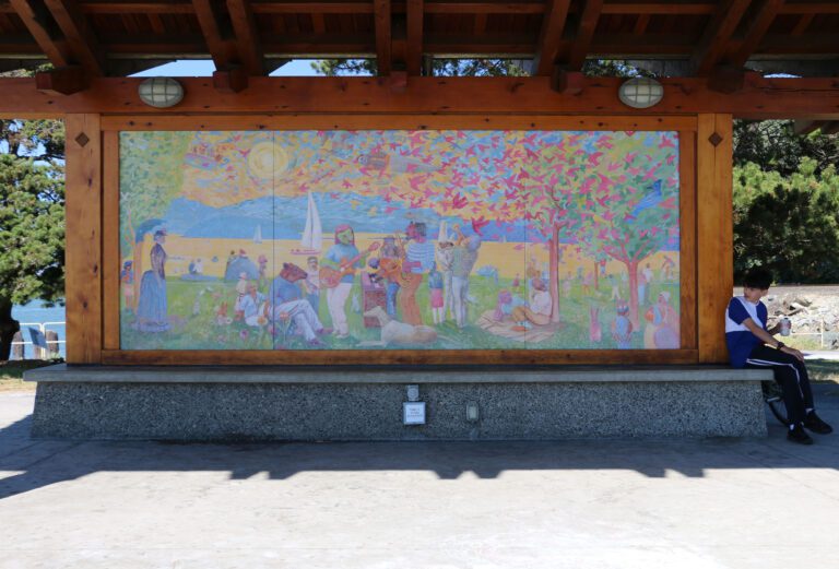 A boy sits by "The Porch" mural July 14. The mural was created in 2009 by painter and printmaker Tom Wood and was unveiled during the pavilion's dedication.