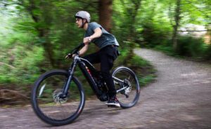 Michael Rodriguez rides an electric mountain bike on a trail in Fairhaven on June 4. This Seattle Electric Bike is designed to provide varying levels of pedal assistance depending on what the rider selects.