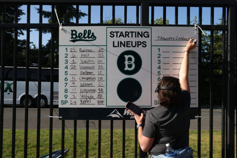 The Bellingham Bells general manager Stephanie Morrell writes the team lineups on opening day.