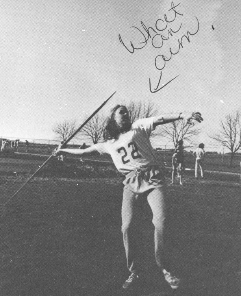 Bonna giller throwing a javelin in her high school jersey.