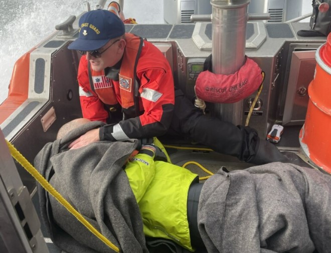 A U.S. Coast Guard crew member tends to a kayaker who was saved after being overturned in Bellingham Bay on Dec. 10.