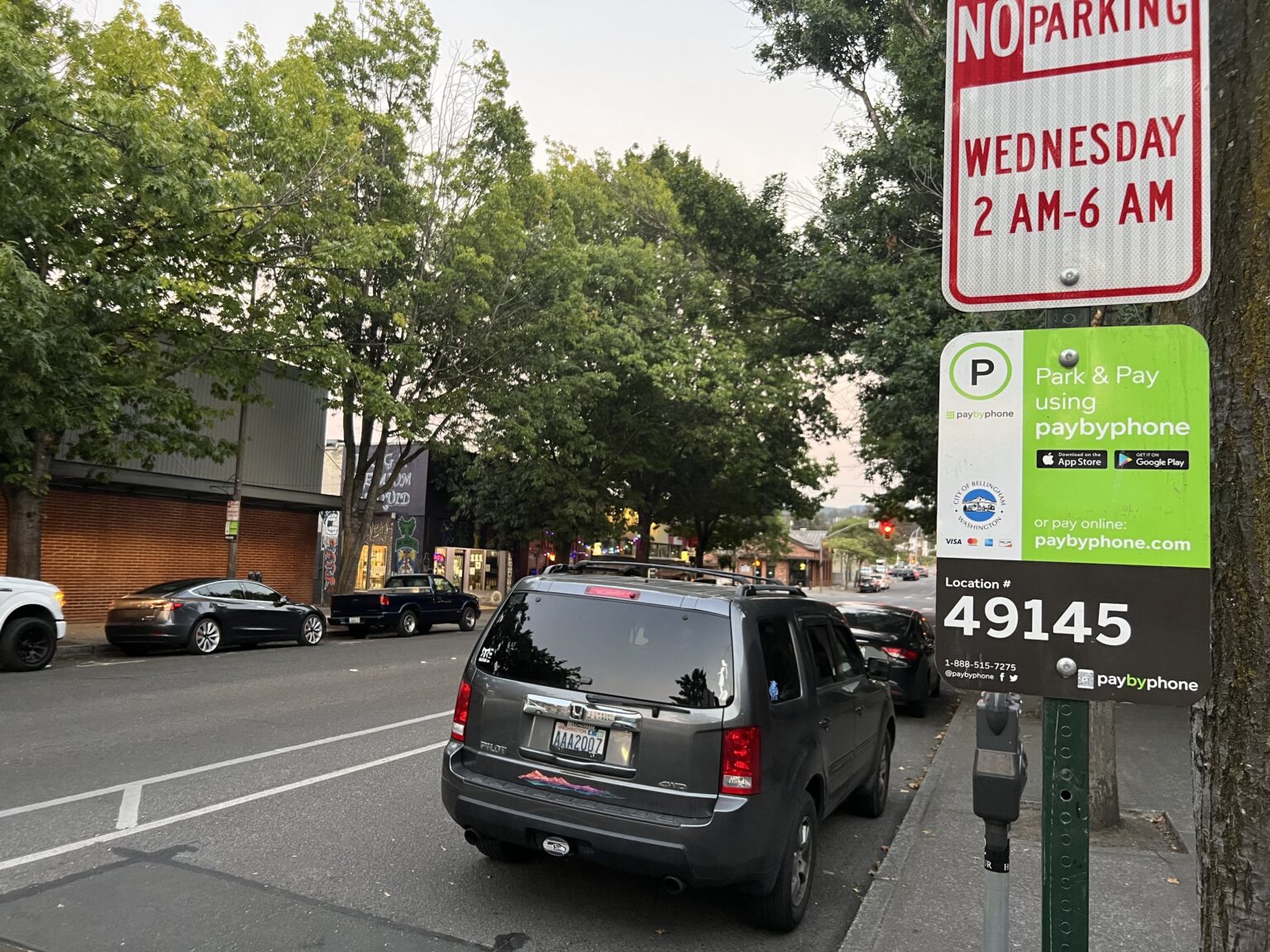 Vehicles park in paid spaces on Bellingham's Magnolia Street in September. Responsibility for parking enforcement in the city will move from the police department to Public Works in the coming months.