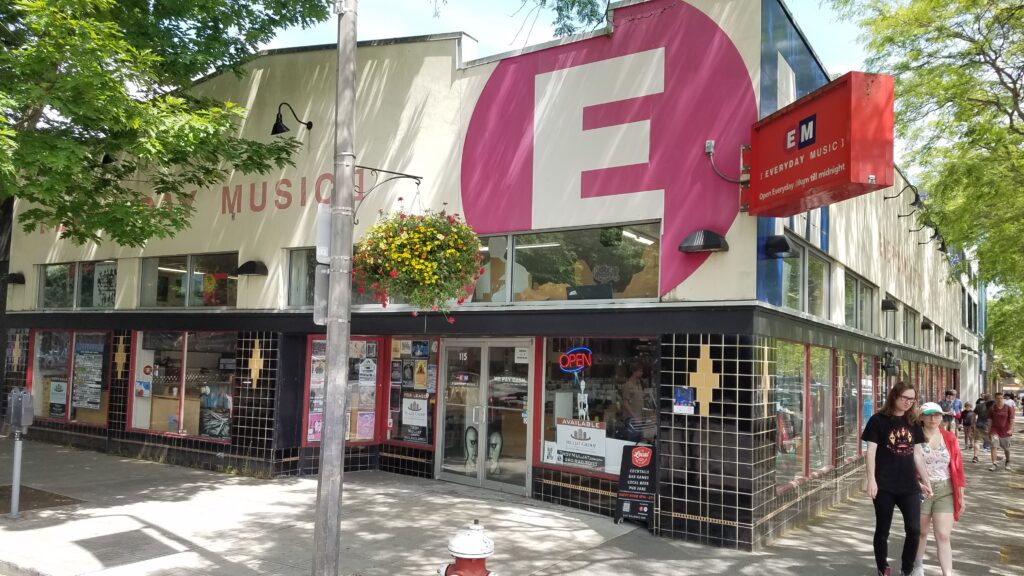 The storefront of Everyday Music before it changed owners as people walk by.