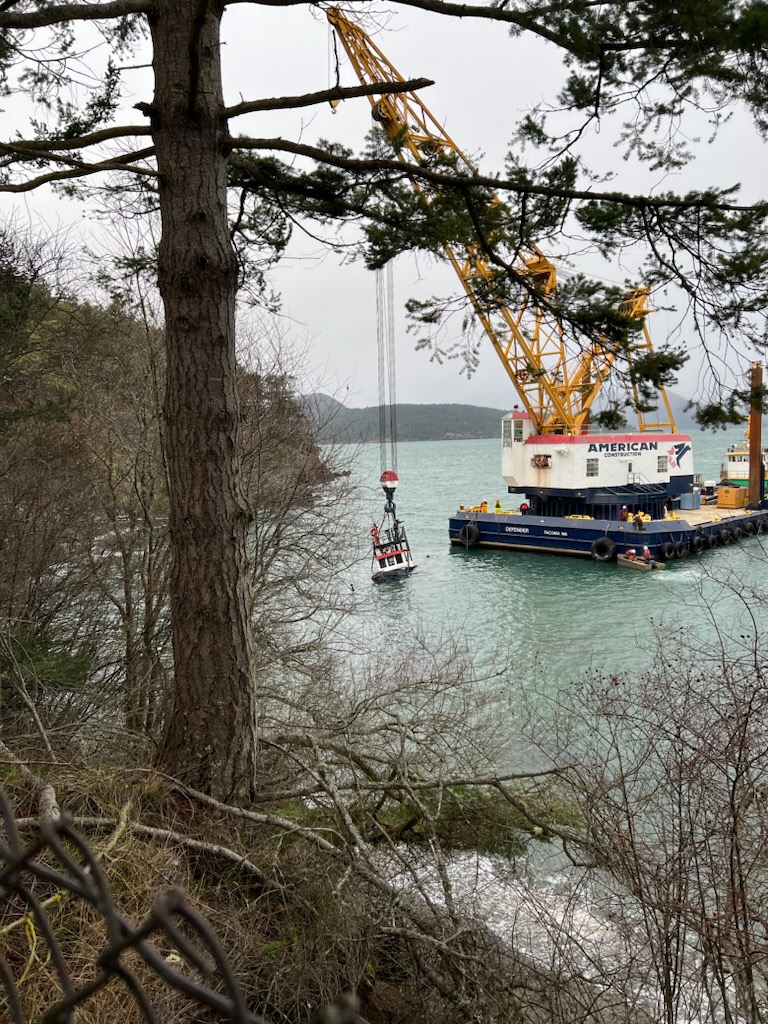 A tugboat that sank off the coast of Lopez Island Feb. 22 gets lifted from the water. The vessel was carrying around 400 gallons of diesel.