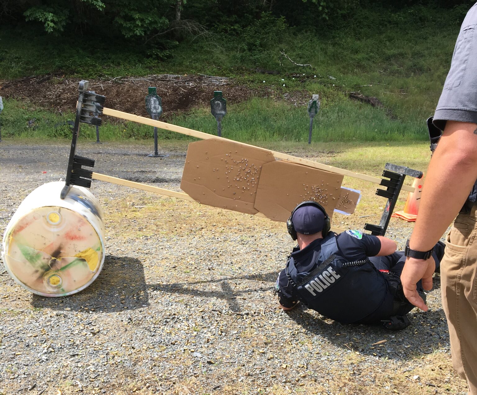 Trainees from the Bellingham Police Department behind a used target.
