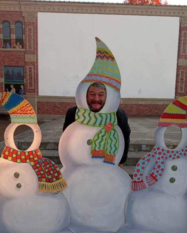 Henry King poses behind a snowman cutout.