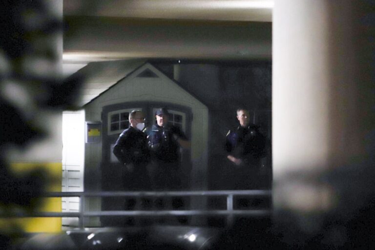 Police gather outside the emergency entrance at PeaceHealth St. Joseph Medical Center Thursday evening after two Whatcom County Sheriff's Deputies were transported to the hospital with gunshot wounds from an incident near Maple Falls.