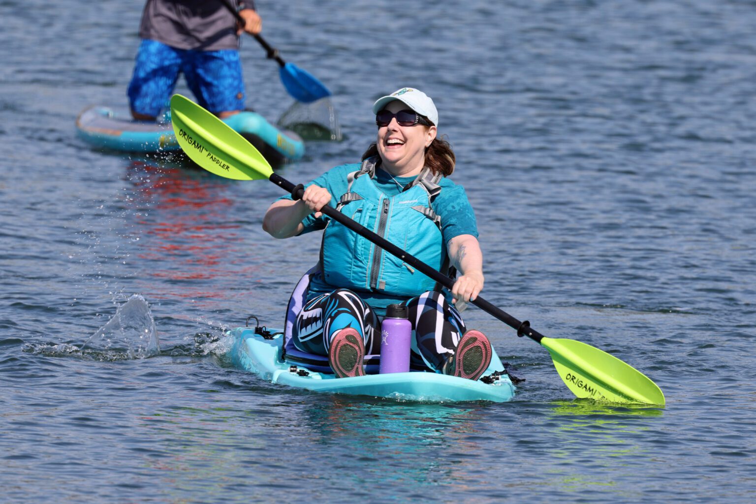 Kari Neumeyer of Bellingham beams as she nears the finish of an ovarian cancer fundraiser and awareness paddling event she organized Saturday on Bellingham Bay. The event drew about three dozen paddlers raising money and drawing attention to the deadly