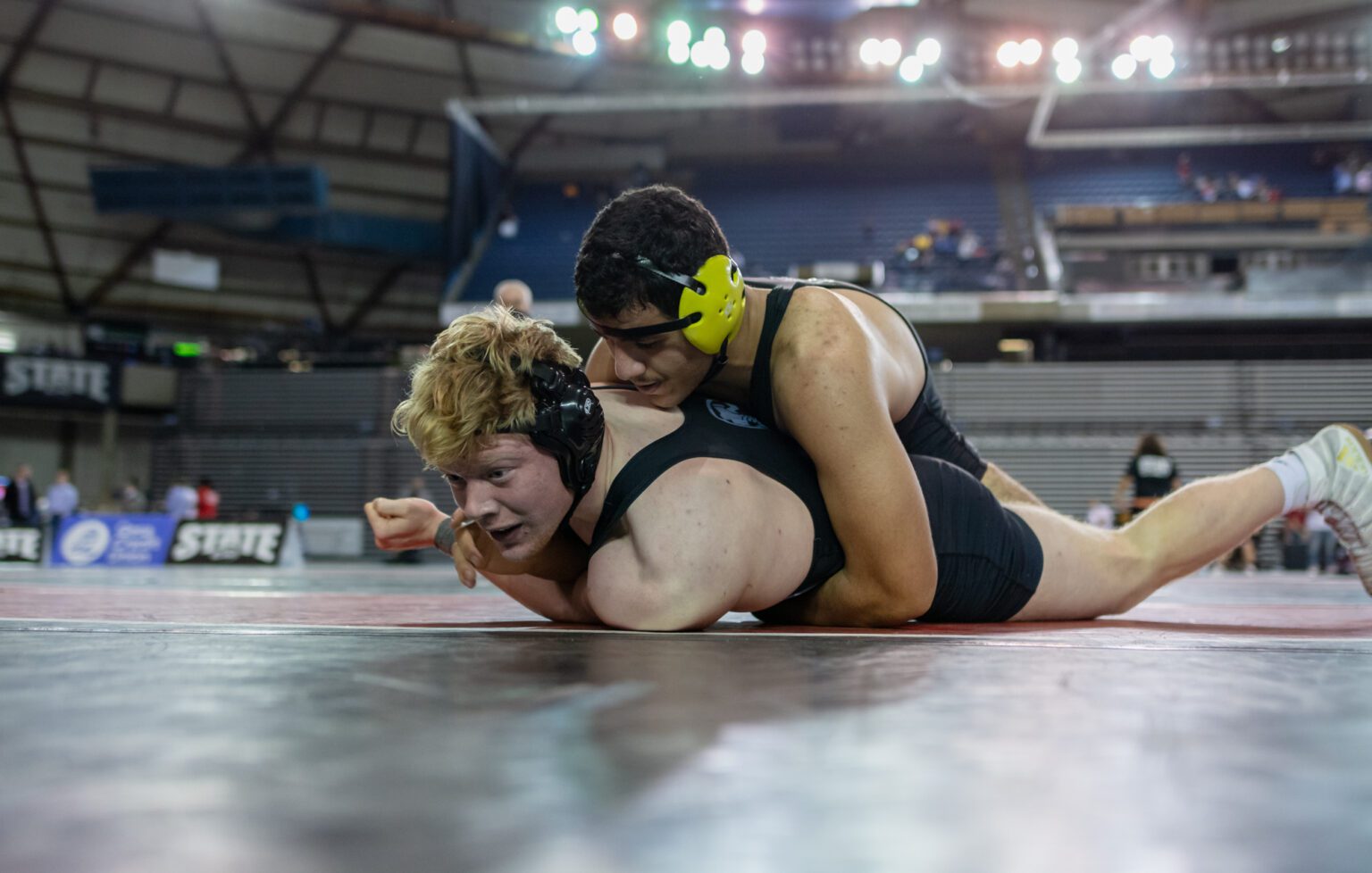 Squalicum's Bryson Lamb tries to get out from under North Kitsap's Sofian Hammou in the 220-pound championship at Mat Classic XXXIII on Saturday at the Tacoma Dome.