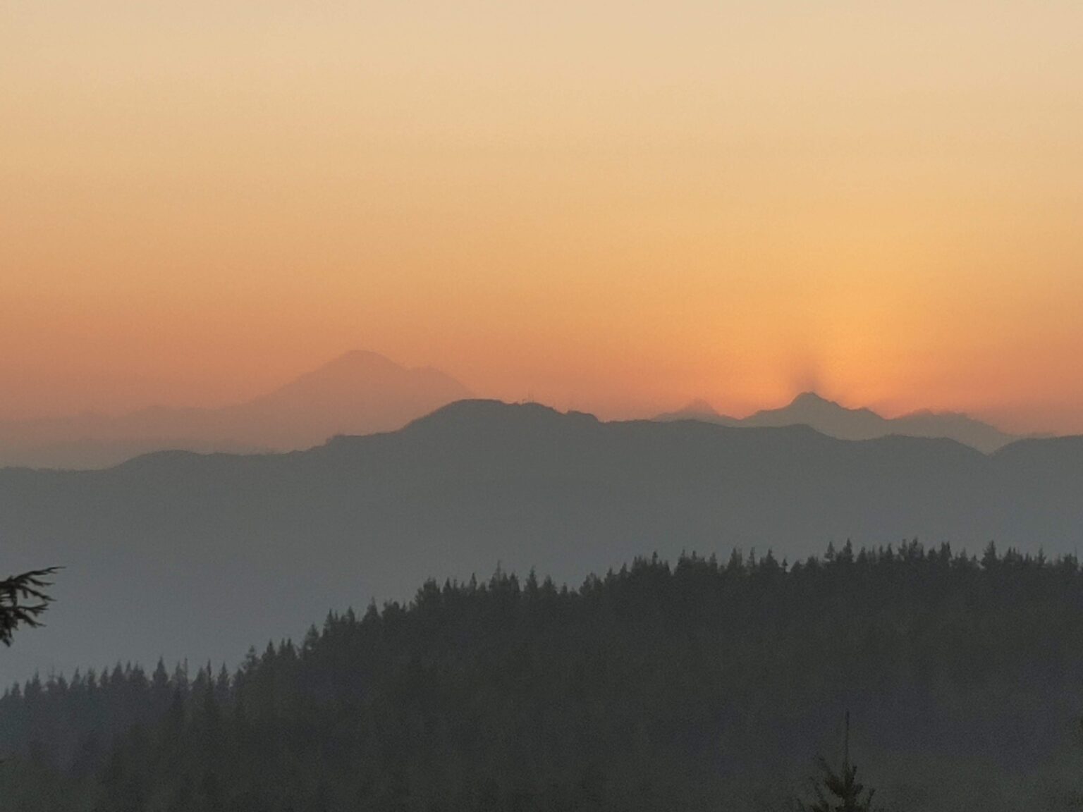 Smoke from summer wildfires hangs behind Mount Baker in September
