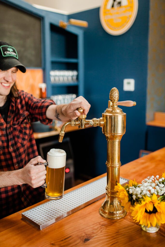 Otherlands Beer co-owner Ben Howe pours from the tap. The brewery in Bellingham's Sunnyland neighborhood celebrated its two-year anniversary on the last weekend in June with the release of Songs of Courtship