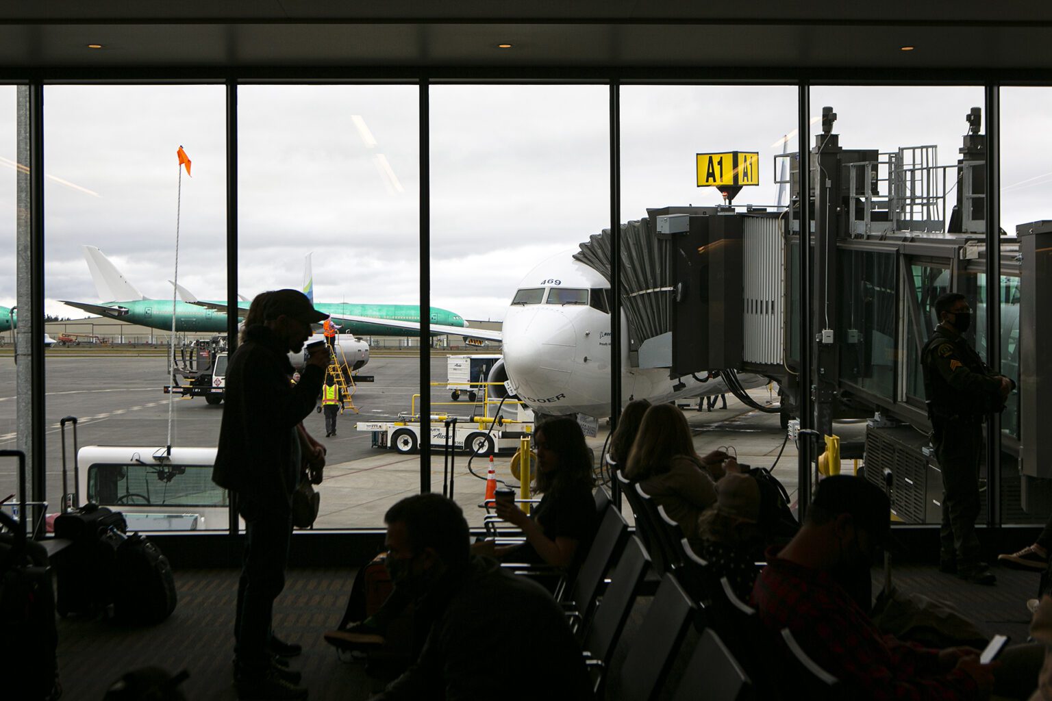 Flyers wait to become the first passengers to depart on a Boeing 737 from Paine Field Airport Thursday