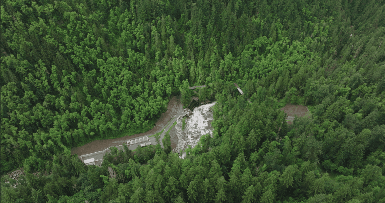 An aerial view of Middle Fork Nooksack Dam surrounded by dense forests.