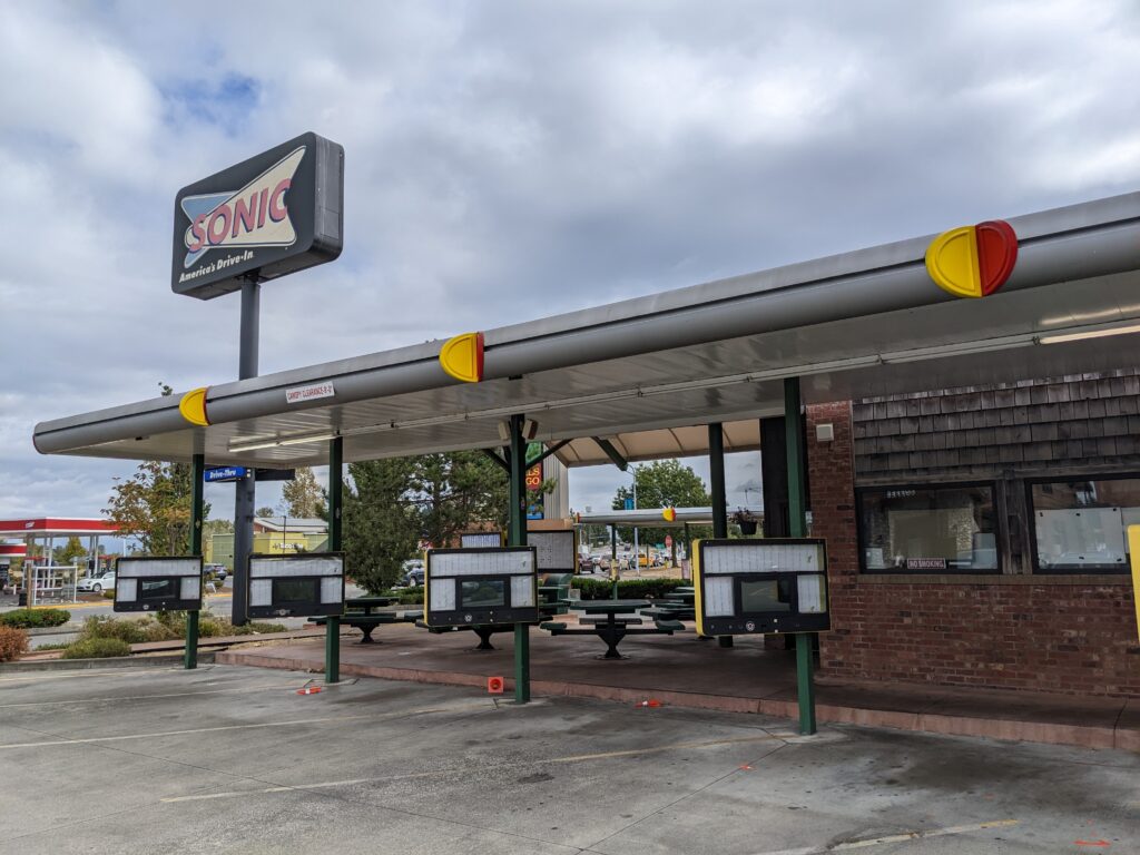 Parking spots and outdoor seating area of a Sonic Drive-In