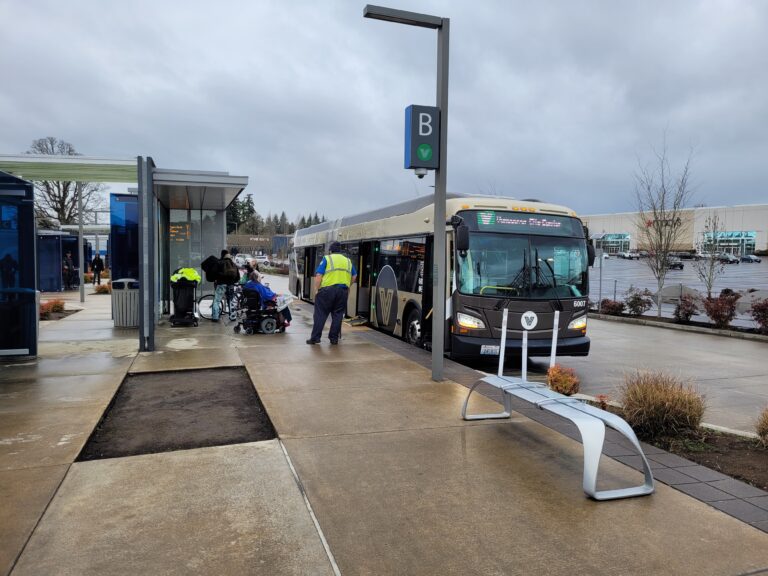Passengers prepare to board a rapid-transit bus in Vancouver