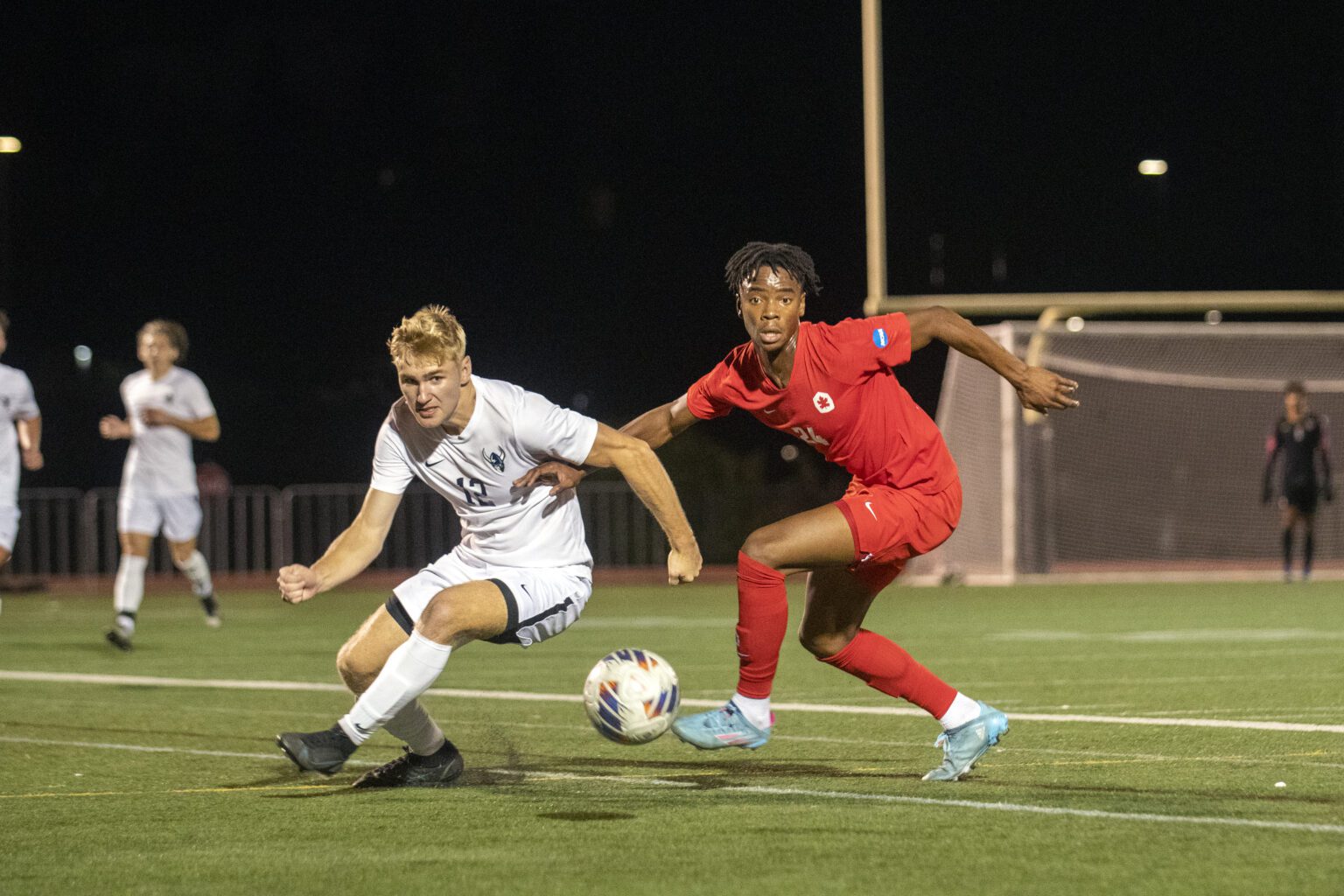 Western Washington University's Theo Steinmetz (12) looks to take possession of the ball against a Simon Fraser player during a road game in Burnaby