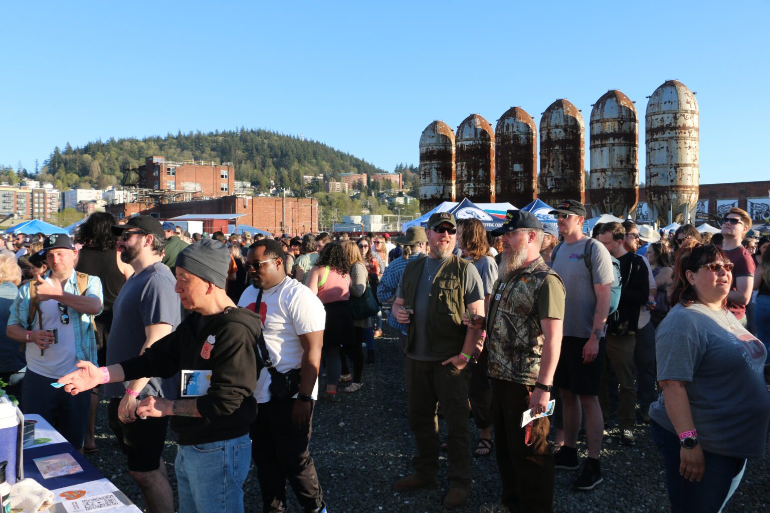 Attendees line up to receive a taste of beer from Birdsview Brewing Company during the April Brews Day festival April 29 at Bellingham's downtown waterfront. The festival returned after a three-year hiatus following the pandemic.