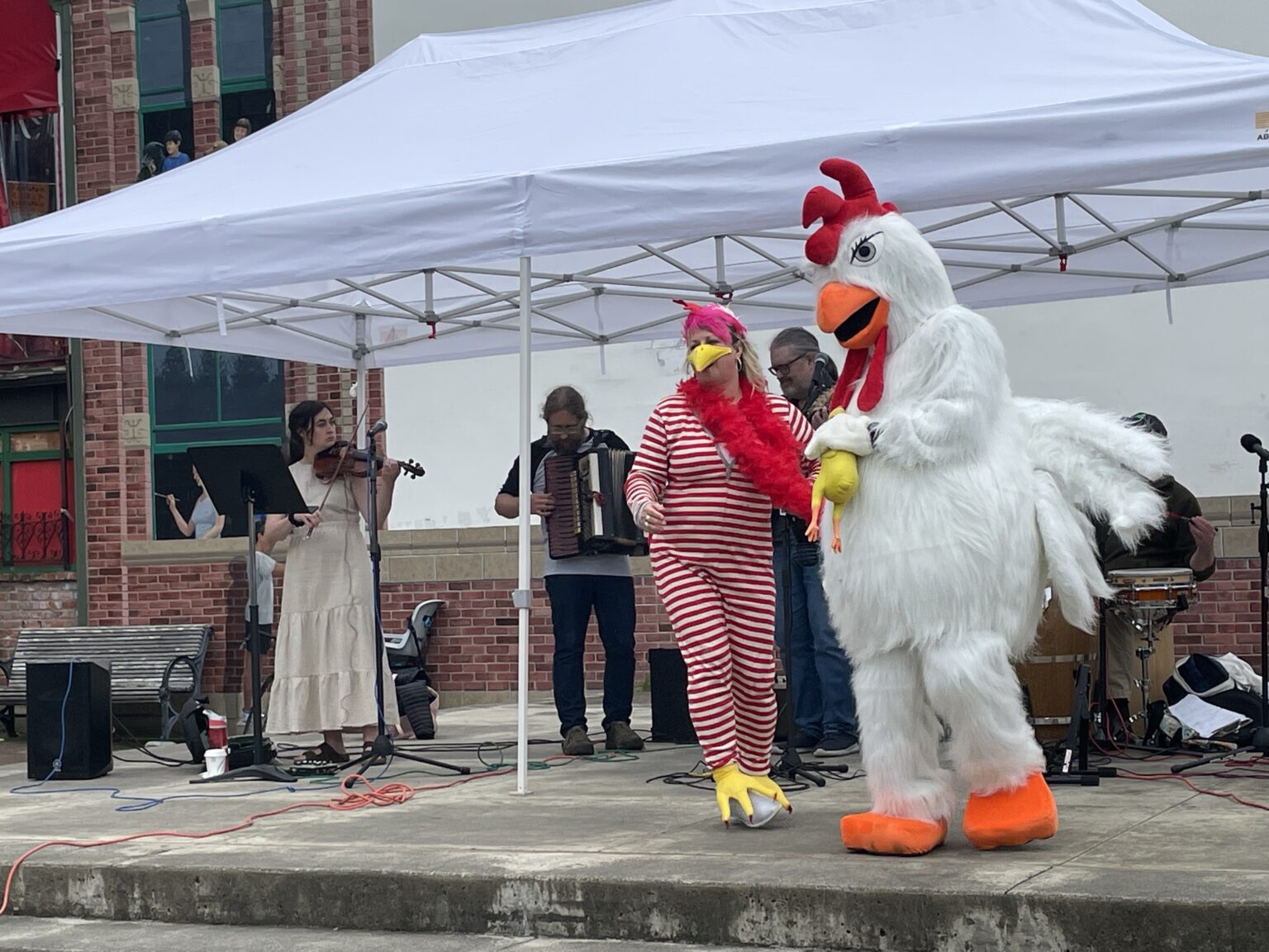 Former Bellingham City Council member Pinky Vargas does the "Chicken Dance" with Fairhaven Chicken Festival mascot Dylan Hartmann during the inaugural event Saturday
