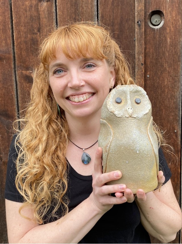 Good Earth Pottery owner Ann Marie Cooper holds an owl sculpture she created for the Whatcom Artists of Clay and Kiln (WACK) exhibit "You Do You